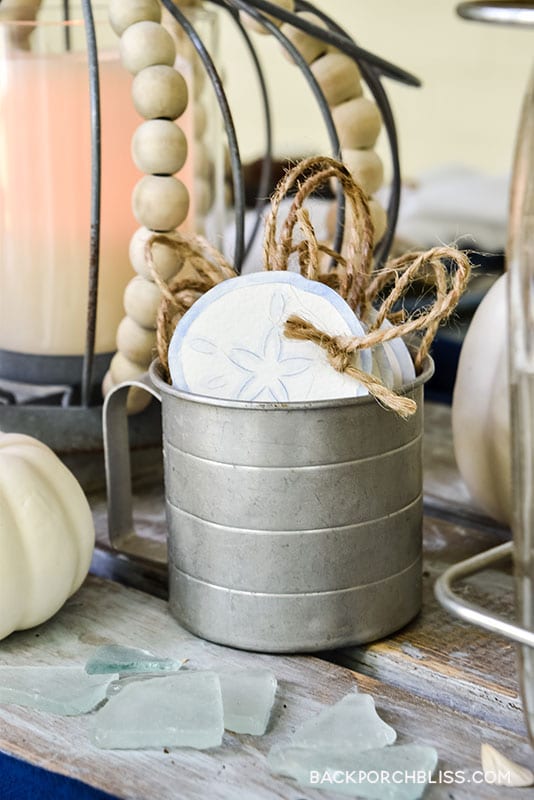 closeup of galvanized cup with sand dollar gratitude cards